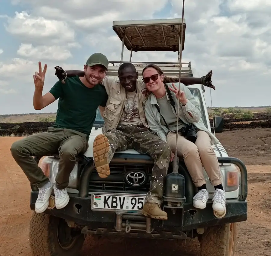 Skynile Adventure Tours Kenya safari packages—Happy travellers and tour guide at the center